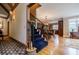 Elegant foyer with staircase leading to the upper level and hardwood floors at 5318 Brooke Farm Dr, Dunwoody, GA 30338