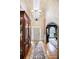 Grand foyer featuring a soaring ceiling, chandelier, hardwood floors, and an elegant arched doorway at 5318 Brooke Farm Dr, Dunwoody, GA 30338
