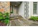 Elegant front door with stone accents and manicured landscaping at 5318 Brooke Farm Dr, Dunwoody, GA 30338