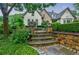 Landscaped front yard with stone steps and lush greenery at 5318 Brooke Farm Dr, Dunwoody, GA 30338