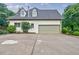 Side view of a house featuring a two-car garage at 5318 Brooke Farm Dr, Dunwoody, GA 30338