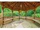 A charming gazebo interior features a wooden floor, benches, and artistic details at 5318 Brooke Farm Dr, Dunwoody, GA 30338