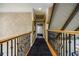 Second story hallway features carpeted floors and dark wood railing at 5318 Brooke Farm Dr, Dunwoody, GA 30338