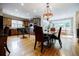 Open kitchen with hardwood floors, center island, stone countertops, and sunroom access at 5318 Brooke Farm Dr, Dunwoody, GA 30338