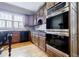 Traditional-style kitchen with wooden cabinets, stainless steel appliances, and hardwood floors at 5318 Brooke Farm Dr, Dunwoody, GA 30338