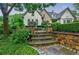 Beautiful landscaping with stone stairs, statues, and lush greenery at 5318 Brooke Farm Dr, Dunwoody, GA 30338