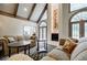 Elegant living room with vaulted ceilings, large windows, and a fireplace for cozy gatherings at 5318 Brooke Farm Dr, Dunwoody, GA 30338