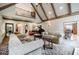 Spacious living room with vaulted ceilings, large windows, comfortable seating, and a grand piano at 5318 Brooke Farm Dr, Dunwoody, GA 30338