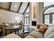 Inviting living room with vaulted ceilings, fireplace, and large windows offering ample natural light at 5318 Brooke Farm Dr, Dunwoody, GA 30338
