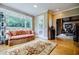 Cozy living room with large windows and hardwood floors, offering peaceful backyard view at 5318 Brooke Farm Dr, Dunwoody, GA 30338