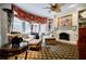 Comfortable living room featuring a fireplace, bookshelves and large windows at 5318 Brooke Farm Dr, Dunwoody, GA 30338