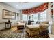 Cozy living room with large windows, fireplace, and built-in shelving at 5318 Brooke Farm Dr, Dunwoody, GA 30338