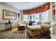 Living room with a fireplace, comfortable seating, and built-in bookshelves at 5318 Brooke Farm Dr, Dunwoody, GA 30338