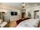 Comfortable main bedroom features a ceiling fan, an entertainment center, and ensuite bathroom and walk-in closet at 5318 Brooke Farm Dr, Dunwoody, GA 30338