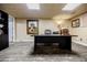 Office space in a finished basement featuring a large desk, neutral walls, and light gray carpet at 5318 Brooke Farm Dr, Dunwoody, GA 30338