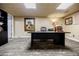 Basement office with a long black desk and drop ceiling with pot lights at 5318 Brooke Farm Dr, Dunwoody, GA 30338