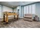 Spacious recreation room with foosball table, ample seating, and natural light from a large window at 5318 Brooke Farm Dr, Dunwoody, GA 30338