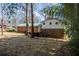 Expansive backyard showcases a brick home with a well-maintained green metal roof and rear deck at 6225 Pebble Dr, Douglasville, GA 30135