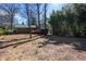View of the large backyard with trees and a small deck attached to this charming brick home at 6225 Pebble Dr, Douglasville, GA 30135