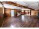 Spacious basement featuring paneled walls, wood-look flooring, and a vintage brick fireplace at 6225 Pebble Dr, Douglasville, GA 30135