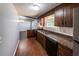 Kitchen area featuring hardwood floors, and dark cabinets with granite countertops at 6225 Pebble Dr, Douglasville, GA 30135