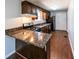 Kitchen with wood cabinets, granite countertops, and stainless steel appliances at 6225 Pebble Dr, Douglasville, GA 30135