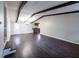 Spacious living room with dark hardwood floors, exposed beam ceiling, and a decorative chandelier at 6225 Pebble Dr, Douglasville, GA 30135