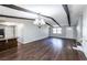 Living room with wood floors, rustic ceiling beams and stylish lighting at 6225 Pebble Dr, Douglasville, GA 30135