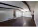 Open-concept living room featuring wood floors, neutral paint, and staircase access at 6225 Pebble Dr, Douglasville, GA 30135