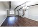 Living room featuring hardwood floors, modern lighting, neutral walls and staircase access at 6225 Pebble Dr, Douglasville, GA 30135