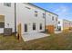 Townhome exterior features a fenced yard with green grass, patio, and modern architecture under a bright sky at 907 Eagle Ave, Riverdale, GA 30296