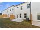 Exterior view of townhome featuring a small fenced backyard, concrete patio, and green grass at 907 Eagle Ave, Riverdale, GA 30296