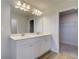 Bathroom showcasing double vanity with modern faucets and a large mirror with great lighting, walk-in closet at 907 Eagle Ave, Riverdale, GA 30296