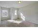 Bedroom featuring wall-to-wall carpet, two windows, and natural light at 907 Eagle Ave, Riverdale, GA 30296