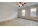 Bedroom featuring wood-look flooring, a ceiling fan, and two windows at 907 Eagle Ave, Riverdale, GA 30296