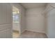Walk-in closet with wire shelving; open to a bathroom featuring a modern vanity and a glass-enclosed shower at 907 Eagle Ave, Riverdale, GA 30296