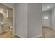 Hallway view with hardwood floors leads to a half-bathroom and front door at 907 Eagle Ave, Riverdale, GA 30296