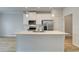 Modern kitchen with white cabinets, stainless steel appliances, and a large island at 907 Eagle Ave, Riverdale, GA 30296