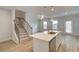 Kitchen island featuring stainless steel appliances, quartz countertops, pendant lights, and open access to the living room at 907 Eagle Ave, Riverdale, GA 30296