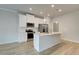 Bright kitchen with white cabinets, stainless steel appliances, and an island with seating at 907 Eagle Ave, Riverdale, GA 30296