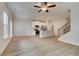 Bright living room featuring wood-look flooring, open access to the kitchen and a carpeted staircase at 907 Eagle Ave, Riverdale, GA 30296