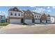 Row of new townhomes featuring brick and siding exteriors and attached garages at 907 Eagle Ave, Riverdale, GA 30296