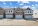 New townhomes feature brick and siding exteriors, attached garages, and landscaping at 907 Eagle Ave, Riverdale, GA 30296