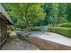 Stone patio with seating area in a beautifully landscaped backyard, perfect for outdoor entertaining and relaxation at 1236 Whitlock Ridge Sw Dr, Marietta, GA 30064