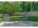 Backyard seating area with metal chairs and table surrounded by lush landscaping and mature trees at 1236 Whitlock Ridge Sw Dr, Marietta, GA 30064