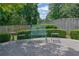 Outdoor seating area in a beautifully landscaped backyard with mature trees and well-maintained landscaping at 1236 Whitlock Ridge Sw Dr, Marietta, GA 30064