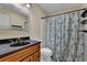 Bathroom featuring a black countertop, toilet and shower with decorative floral curtain at 1236 Whitlock Ridge Sw Dr, Marietta, GA 30064