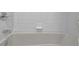 Clean and bright all-white tiled bathtub with chrome fixtures at 1236 Whitlock Ridge Sw Dr, Marietta, GA 30064