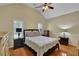 Bedroom featuring hardwood floors, neutral walls, plantation shutters and a ceiling fan at 1236 Whitlock Ridge Sw Dr, Marietta, GA 30064