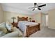 Comfortable bedroom featuring a rustic wood bed frame, neutral walls and a ceiling fan at 1236 Whitlock Ridge Sw Dr, Marietta, GA 30064